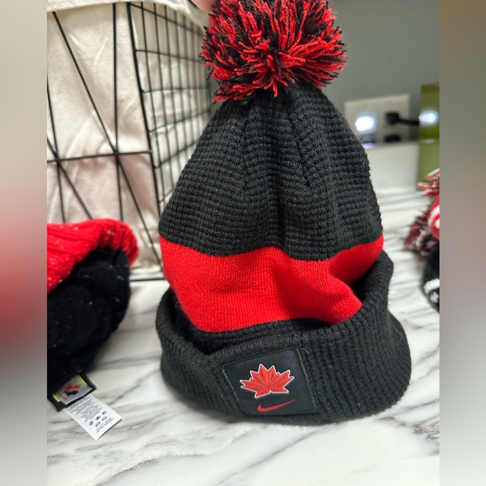 Nike- Team Canada Black and red winter hat with removable poof.